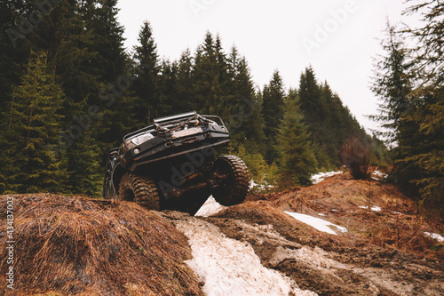 Fotografie Offroad car jump in the mountains