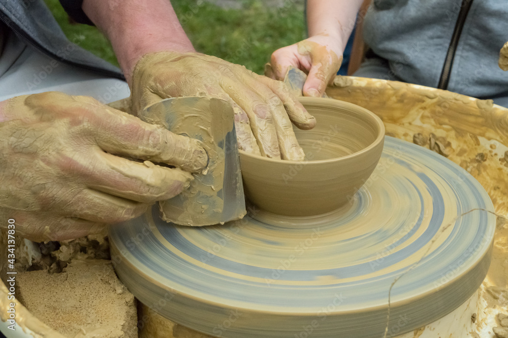 traditional pottery - master and young apprentice