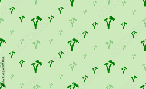 Seamless pattern of large and small green palm trees symbols. The elements are arranged in a wavy. Vector illustration on light green background © Alexey