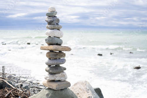 Stacks of balanced round stones on beach. Zen concept