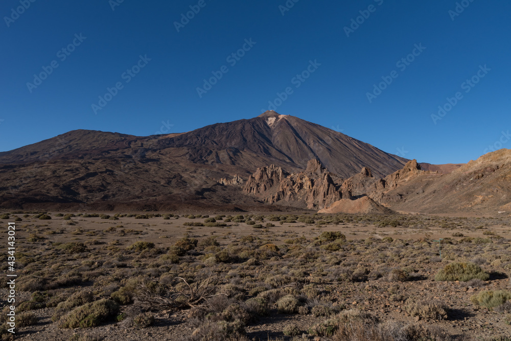 View of Roques de García unique rock formation with famous Pico del Teide mountain volcano summit in the background on a sunset, Teide National Park, Tenerife, Canary Islands, Spain