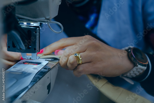 Closeup shot of a worker sewing in a textile factory