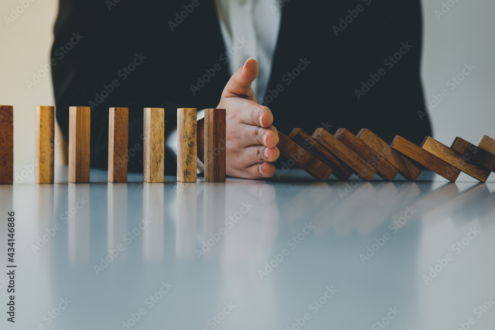 Businesswoman protect wooden block fall to planning and strategy in risk to business Alternative and prevent. Investment Insurance ,Business risk control concept,