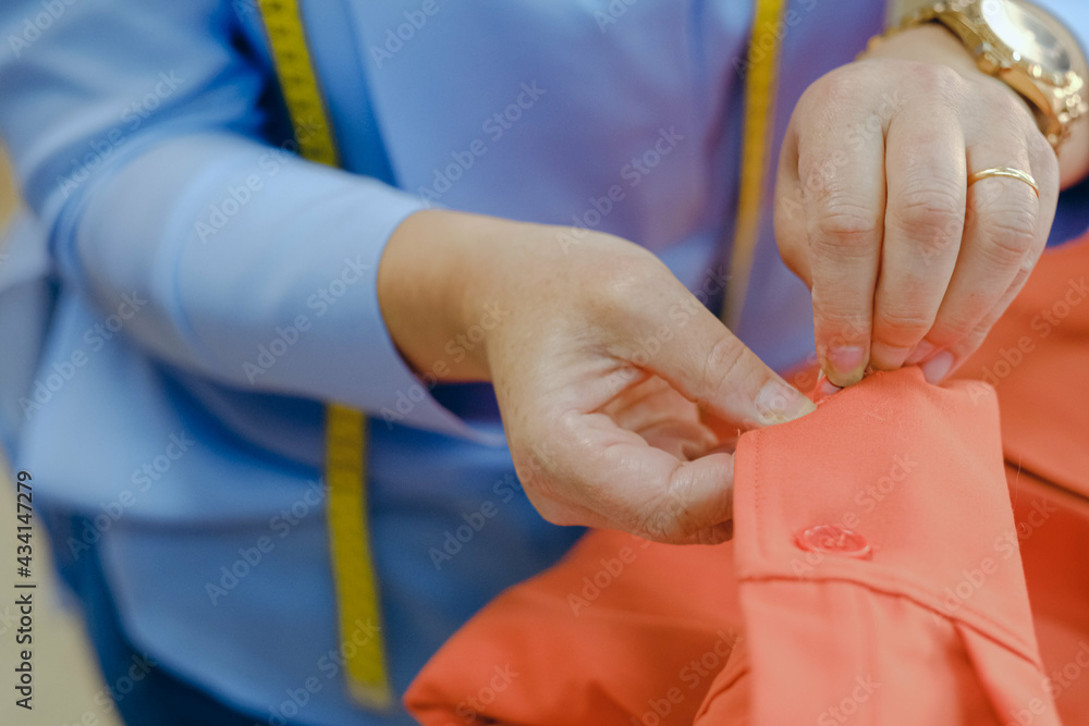 Closeup shot of workers sewing in a textile factory Closeup shot of workers sewing in a textile factory