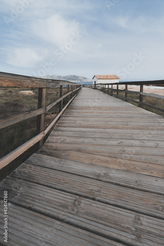 Vertical shot of a wooden path near the Mediterranean sea in Spain