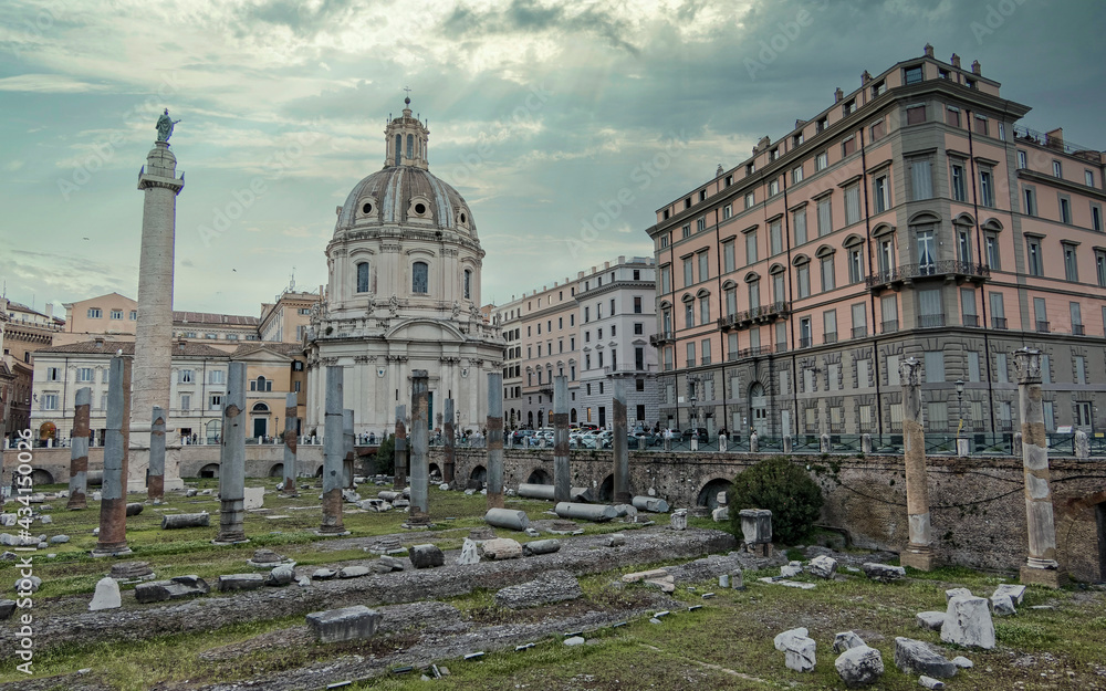 Fototapeta premium Rome Italy, picturesque view of the Trajan forum under dramatic cloudy sky and sun rays