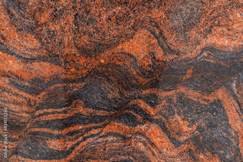 the texture of the stone is marble. Natural texture of polished stone brown color, black streaks