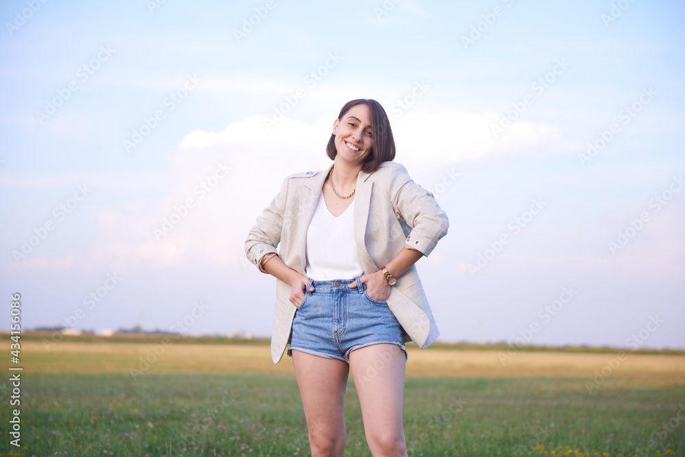 Natural beauty smiling outside in her shorts and jacket Natural beauty smiling outside in her shorts and jacket