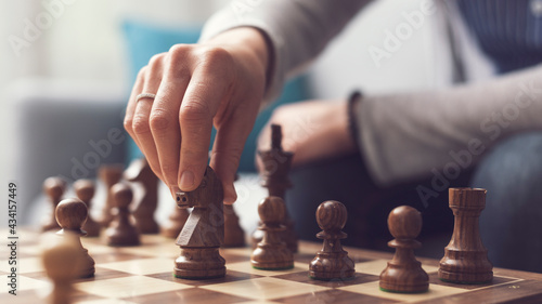 Woman playing chess hand close up