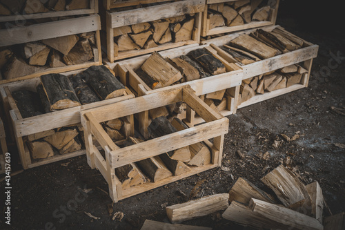 Set of cut firewood. Firewood in wooden crates. Piles of firewood.