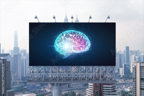 Brain hologram on billboard with Kuala Lumpur cityscape background at day time. Street advertising poster. Front view. KL is the largest science hub in Malaysia, Asia. Coding and high-tech science.
