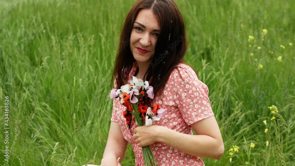 Young beautiful woman walking along a poppy field in summer. Lovely young romantic woman posing against the background of a field in a bouquet of poppies of different flowers on a summer day.
Young beautiful woman walking along a poppy field in summer. Lovely young romantic woman posing against the background of a field in a bouquet of poppies of different flowers on a summer day.