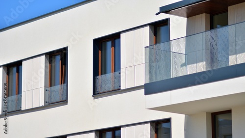 Condominium and apartment building with symmetrical modern architecture. Detail in modern residential flat apartment building exterior. Fragment of new luxury house and home complex. 