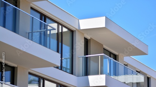 Condominium and apartment building with  symmetrical modern architecture. Detail in modern residential flat apartment building exterior. Fragment of new luxury house and home complex.  © Grand Warszawski