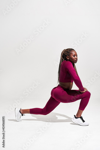 Wallpaper Mural Black sportswoman in activewear training on white background Torontodigital.ca