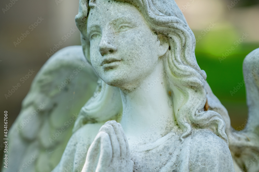 Tender beautiful angel praying. Fragment of an ancient statue. Tender beautiful angel praying. Fragment of an ancient statue.