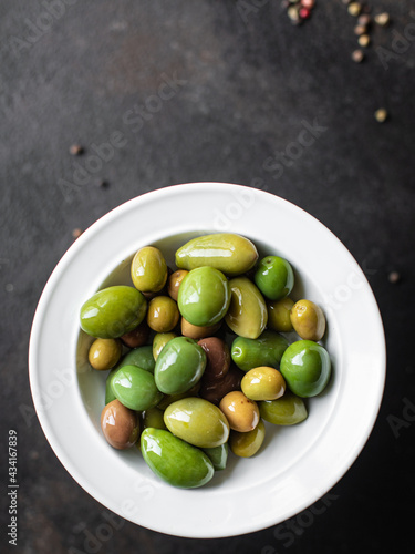 olive pitted plate on the table varieties fruits vegan vegetarian food snack trend meal copy space food background rustic top view 