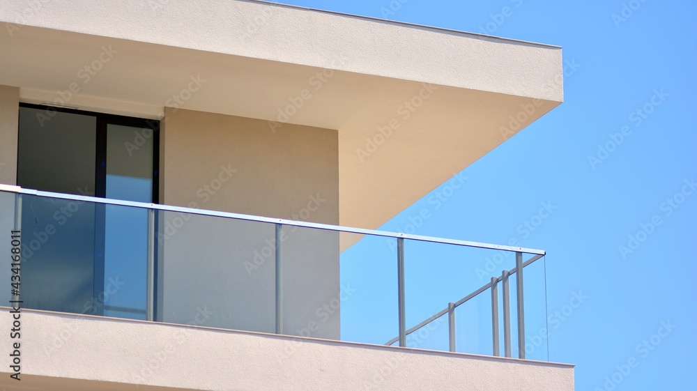 Condominium and apartment building with symmetrical modern architecture. Detail in modern residential flat apartment building exterior. Fragment of new luxury house and home complex. Condominium and apartment building with symmetrical modern architecture. Detail in modern residential flat apartment building exterior. Fragment of new luxury house and home complex.