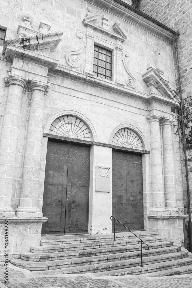 Segorbe, province of Castello, Valencian Community, Spain. Cathedral of the Assumption of Our Lady of Segorbe entrance. Beautiful Roman Catholic church. Black and white photography.