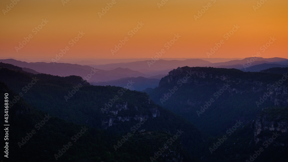 Closeup shot of a landscape with colorful sky after sunset