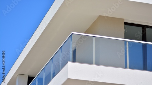 Condominium and apartment building with symmetrical modern architecture. Detail in modern residential flat apartment building exterior. Fragment of new luxury house and home complex. 