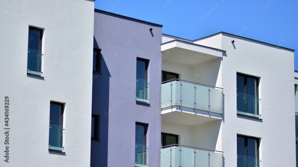 Condominium and apartment building with  symmetrical modern architecture. Detail in modern residential flat apartment building exterior. Fragment of new luxury house and home complex. 