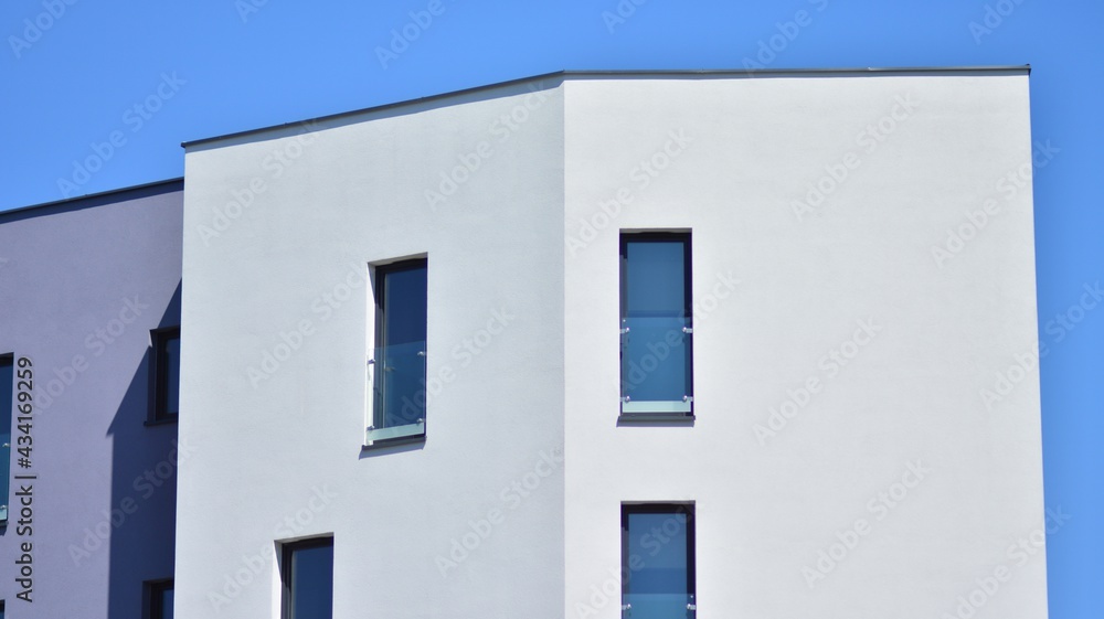 Condominium and apartment building with  symmetrical modern architecture. Detail in modern residential flat apartment building exterior. Fragment of new luxury house and home complex.