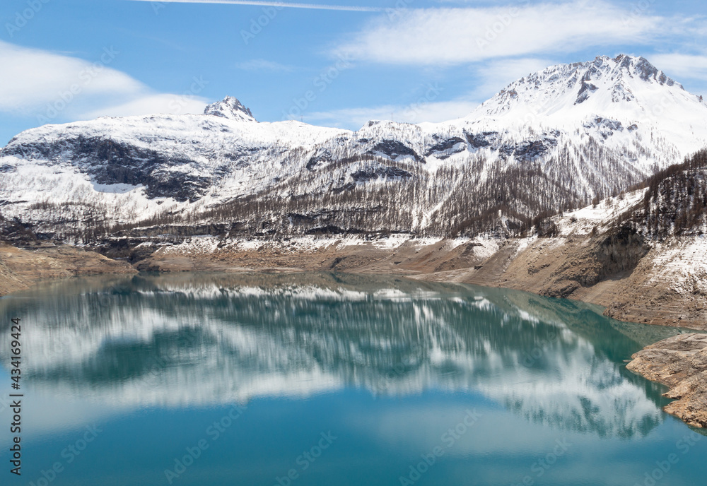 Mountains with snow and lake in the French Alps Tignes