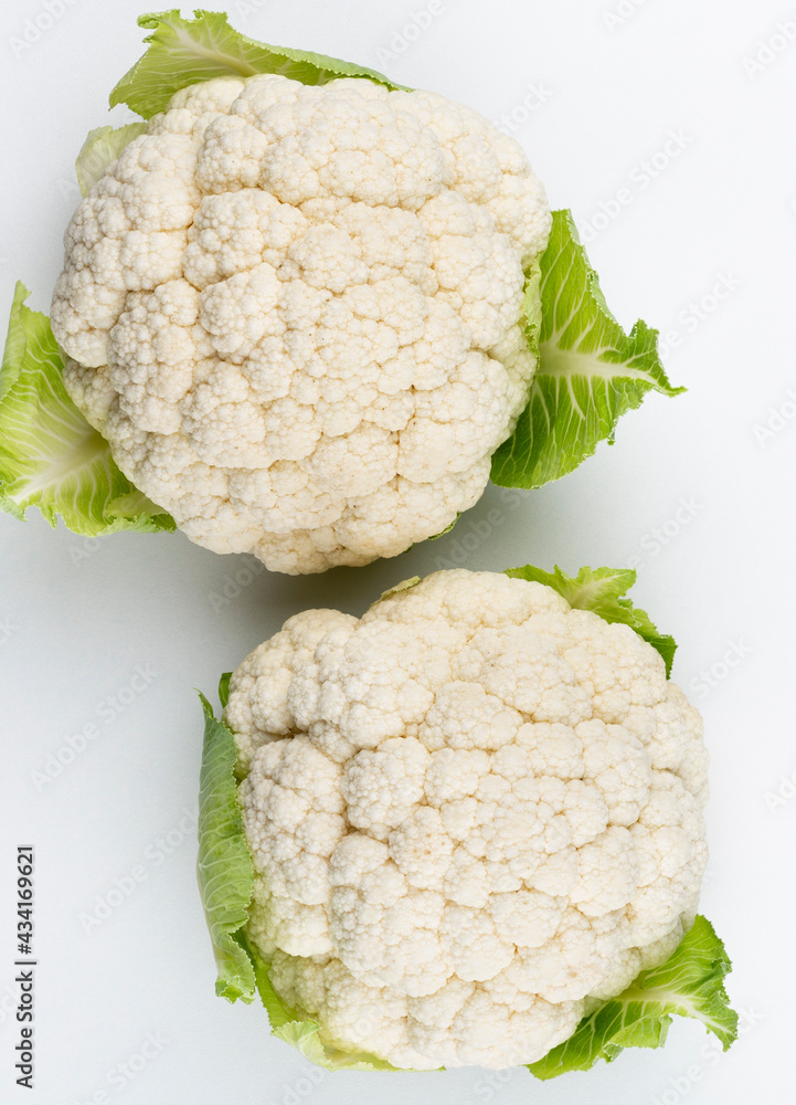 A head of fresh cauliflower. Healthy eating and vegetarianism. Color background. A head of fresh cauliflower. Healthy eating and vegetarianism. Color background.