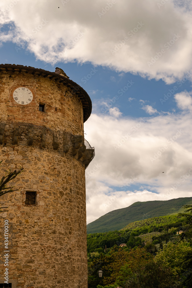 Closeup of an ancient medieval tower with clock, Tuscany, Italy. Closeup of an ancient medieval tower with clock, Tuscany, Italy.