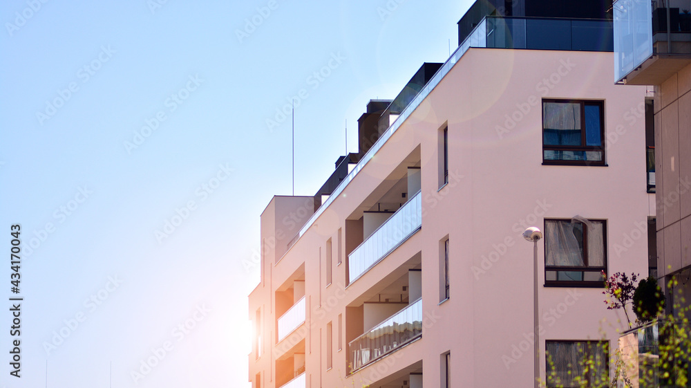 Apartment residential house and home facade architecture and outdoor facilities. Blue sky on the background. Sunlight in sunrise.