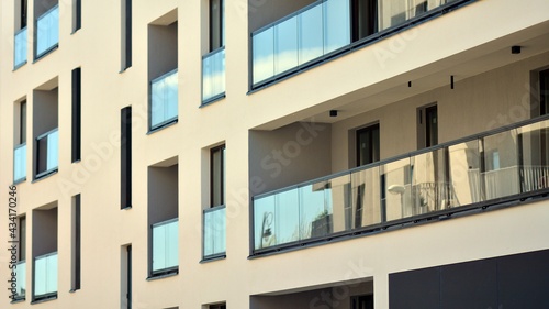 Condominium and apartment building with symmetrical modern architecture. Detail in modern residential flat apartment building exterior. Fragment of new luxury house and home complex.