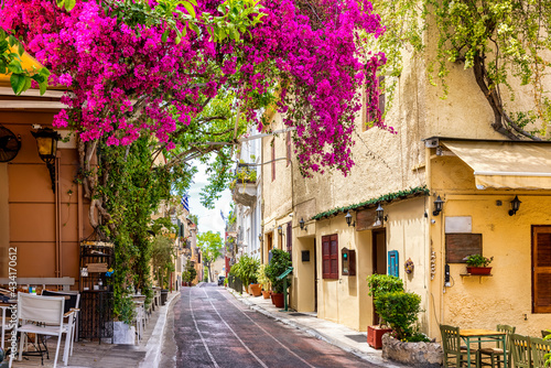 Beautiful view to the little streets of the old town Plaka of Athens  Greece with colorful houses and blooming bougainvillea flowers