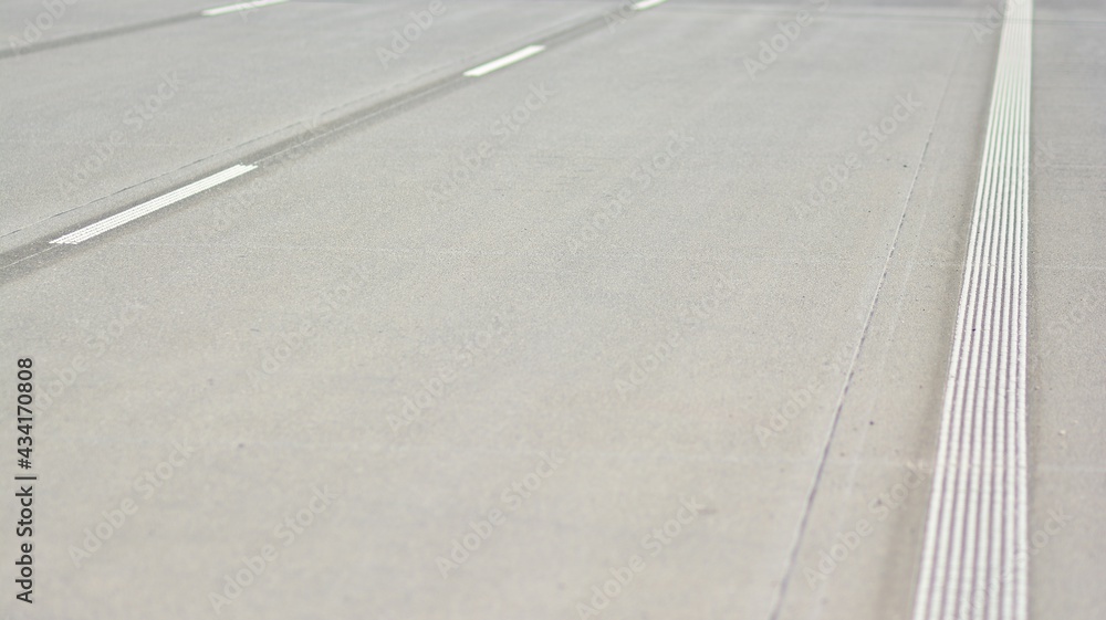 Fototapeta premium Straight modern concrete motorway with bright road marking. Transportation road system infrastructure. 