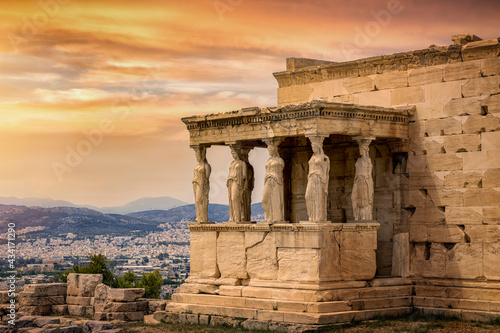 Detailed view of the Erechtheion temple at the Acropolis of Athens, Greece, during a colorful sunset in summer time