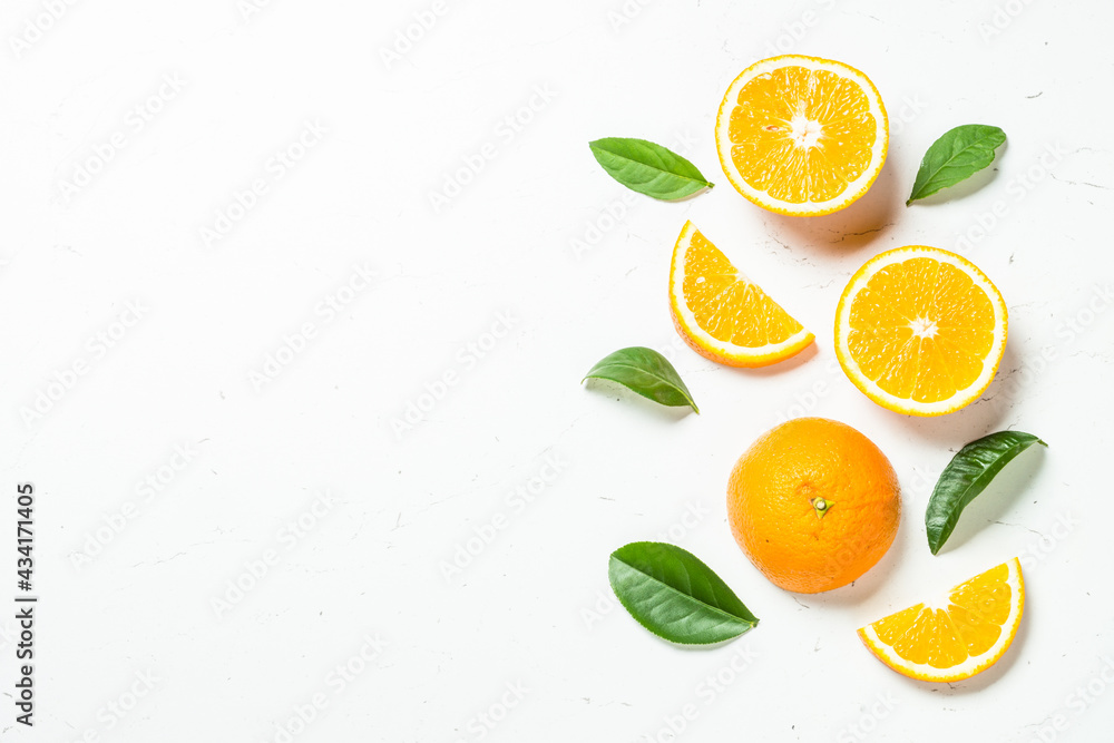 Citrus fruits at white background. Orange, lemon, lime with green leaves. Top view with copy space. Citrus fruits at white background. Orange, lemon, lime with green leaves. Top view with copy space.