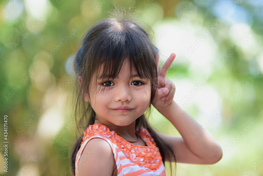 Happy little adorable asian girl Take a walk in the garden in the morning sunny and bright. Happy little adorable asian girl Take a walk in the garden in the morning sunny and bright.