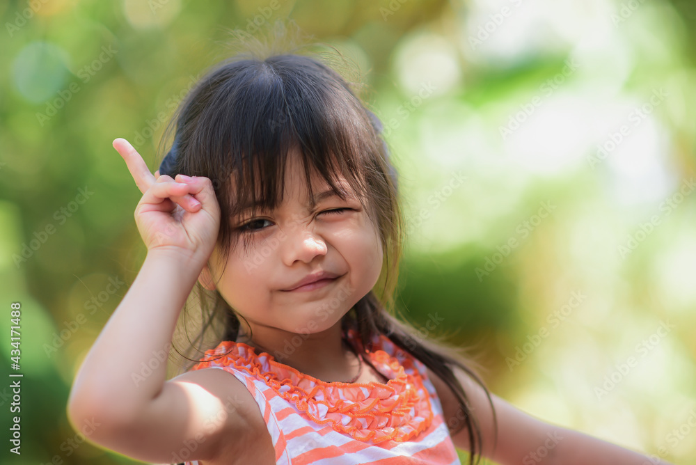 Happy little adorable asian girl Take a walk in the garden in the morning sunny and bright. Happy little adorable asian girl Take a walk in the garden in the morning sunny and bright.