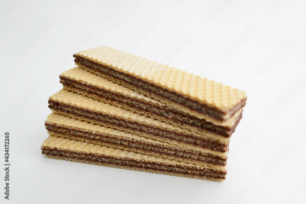 Wafers stick isolated on white background. Wafers biscuit. Pile of rectangle shaped wafer biscuits isolated on white background. Wafers stick isolated on white background. Wafers biscuit. Pile of rectangle shaped wafer biscuits isolated on white background.