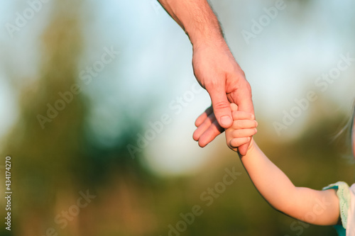 Daughter holds dad's hand © Ekaterina
