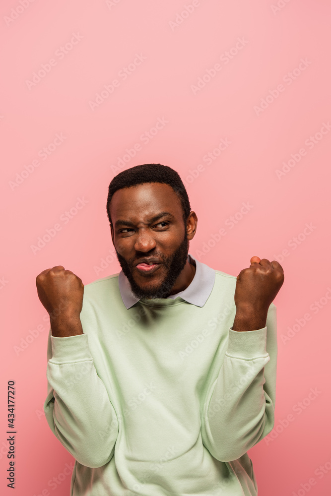 Excited african american man showing yes gesture isolated on pink Excited african american man showing yes gesture isolated on pink