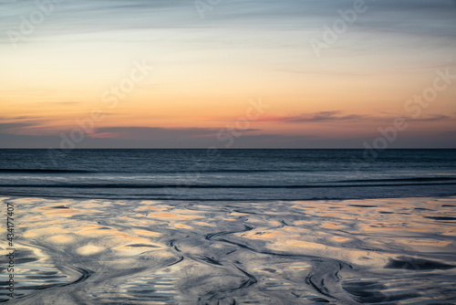 Absolutely beautiful landscape images of Holywell Bay beach in Cornwall UK during golden hojur sunset in Spring