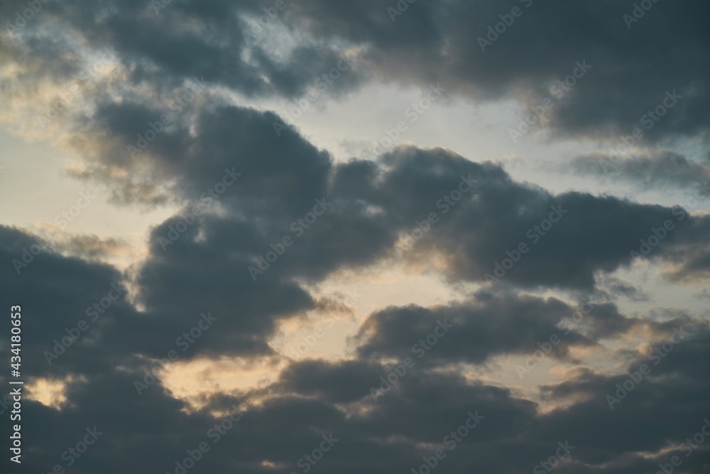 Background of dark clouds before a thunder-storm. Cumulus clouds moving in the sky. Evening sky cloudscape