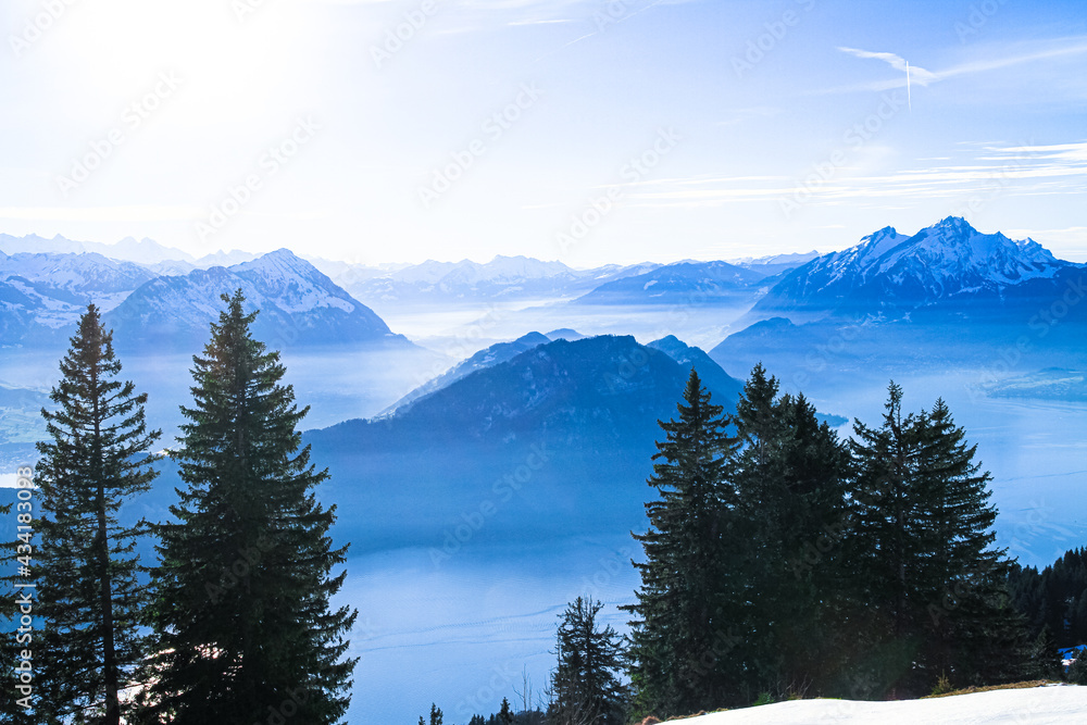 Swiss Alps Mount Pilatus towering over foggy misty Vierwaldstattersee, Lake Lucern, Switzerland