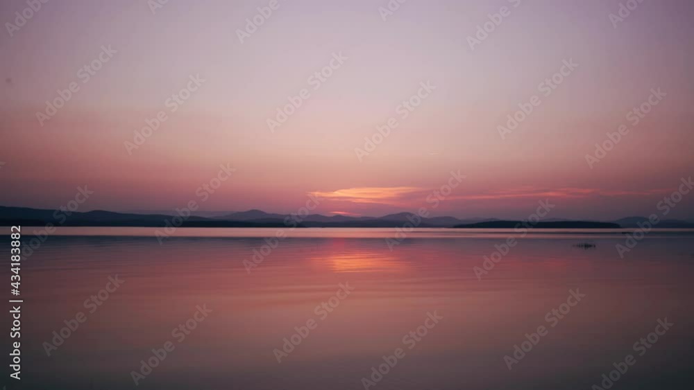 Beautiful sunset on the lake in summer Red sunset over the horizon Reflection of the crimson sun in the water Amazing landscape Beautiful sunset on the lake in summer Red sunset over the horizon Reflection of the crimson sun in the water Amazing landscape