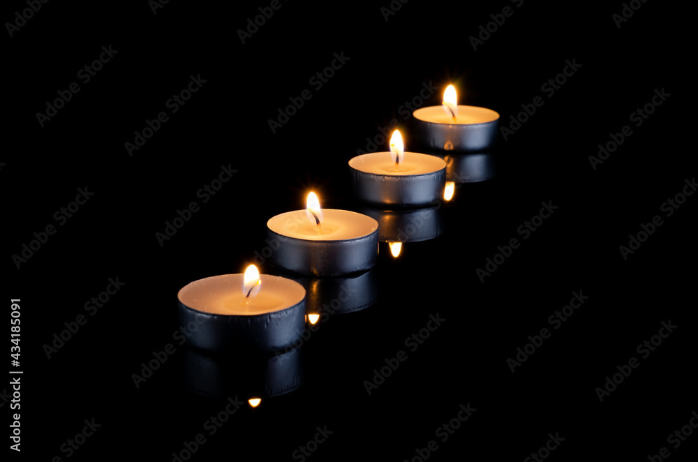 Group of burning candles on black background. Group of burning candles on black background.