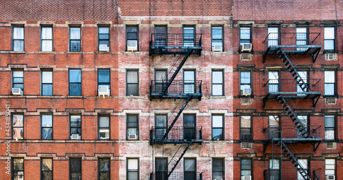 Canvas Print Old brick apartment buildings with windows and fire escapes along Second Avenue