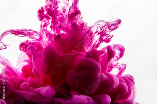 Ink drop in water. Abstract background. Pink background.