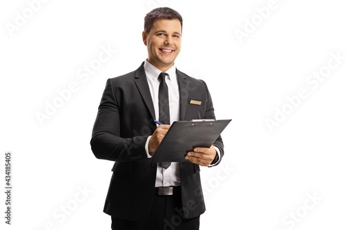 Young elegant man with a name tag on his suit holding a clipboard