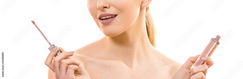The beautiful woman holding a lip gloss on the white background The beautiful woman holding a lip gloss on the white background